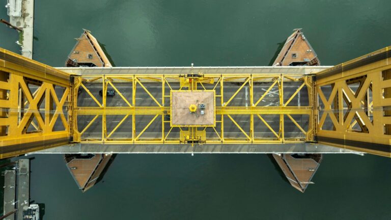 A yellow bridge over a body of water