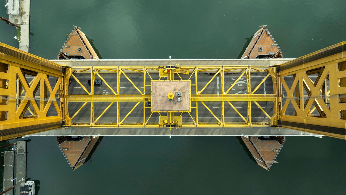 A yellow bridge over a body of water